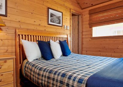 queen bed inside a cabin